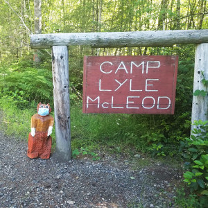 Tajar statue stands in front of the Camp Lyle McLeod sign