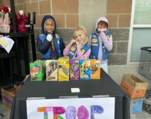 Girl Scouts at a cookie booth