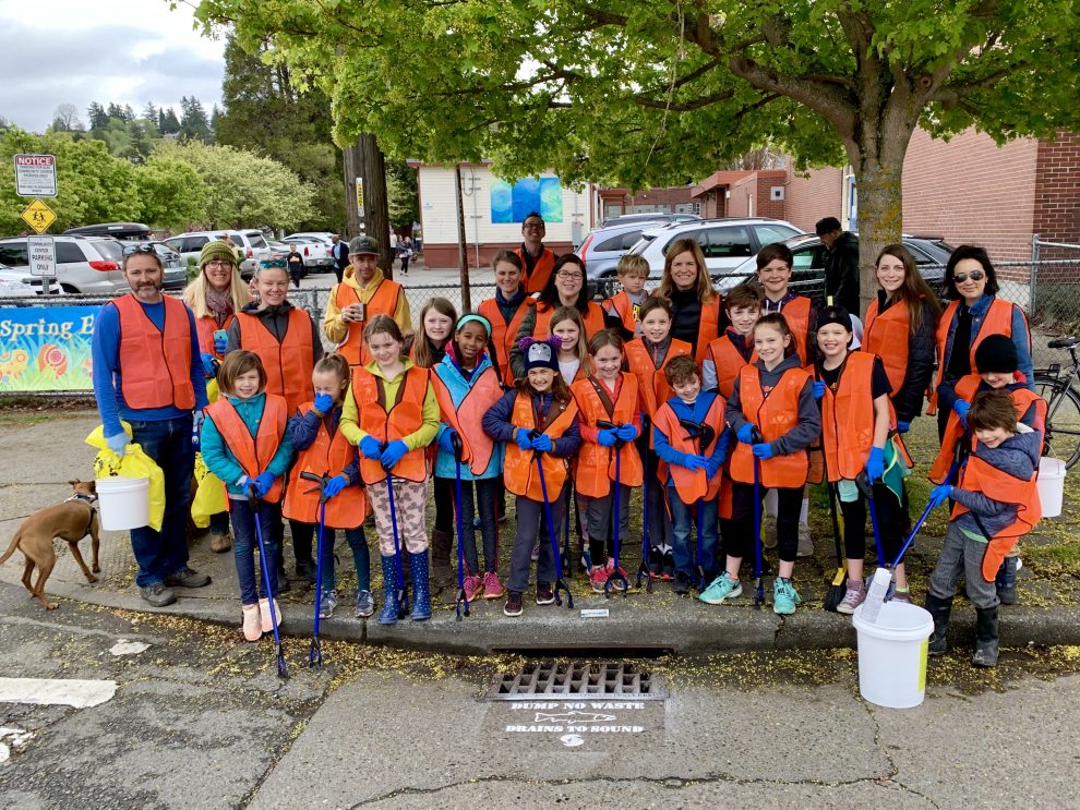 Girl Scouts of Western Washington gathered on sidewalk with cleaning gear