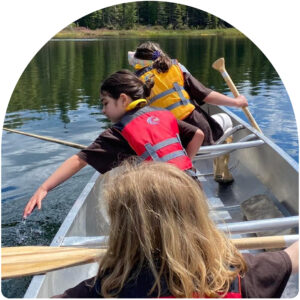 Three Girl Scouts in a canoe