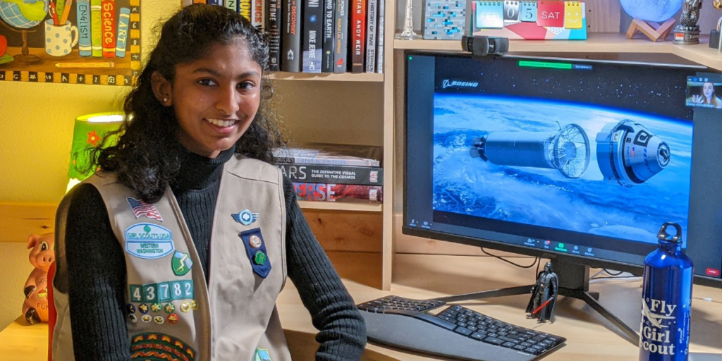 Girl Scout in front of computer