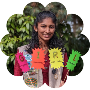 Girl Scout holding up individual signs spelling out GIRL