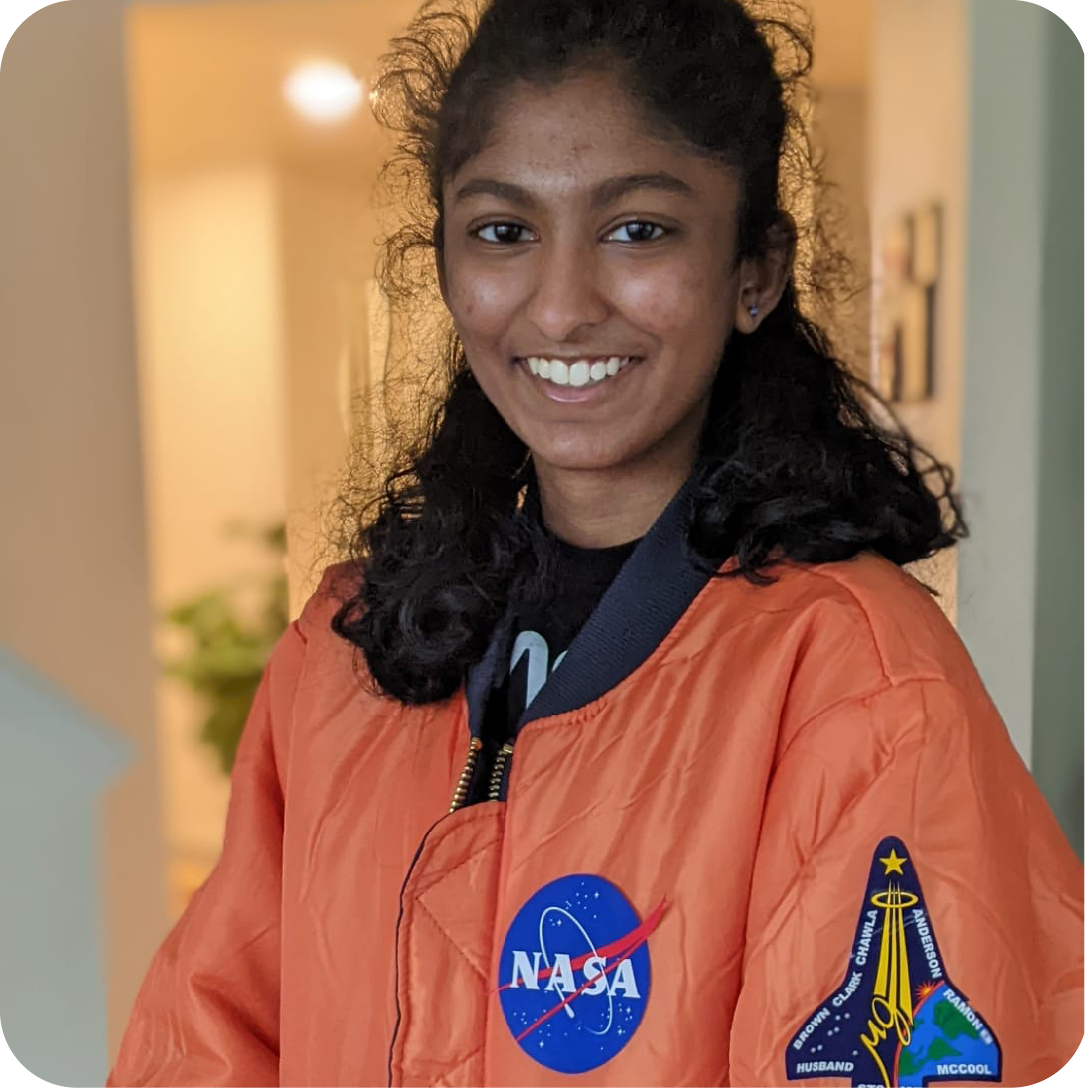 Girl Scout in orange NASA jacket
